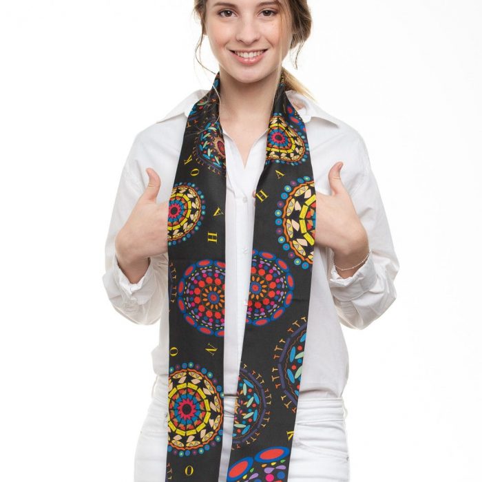 Model wearing the Gratitude twilly knotted on a jacket lapel, highlighting the rhythmic red, yellow, and orange accents.