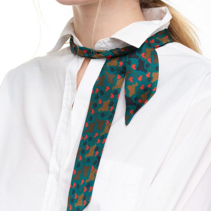 Abstract shot of the Camila twilly design, focusing on the rhythmic placement of hearts and dog leashes, celebrating life's small pleasures.