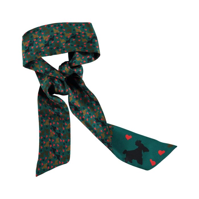 Camila twilly tied to a handbag, showcasing the sweet pattern of dog footprints, hearts, and leashes. Unique versatile silk accessory.