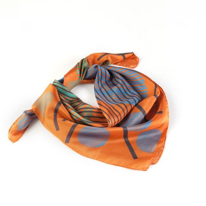 Stacked 'Sphere in the sky' silk scarves, emphasizing the powerful energy and modern artistry of the orange and multi-colored design