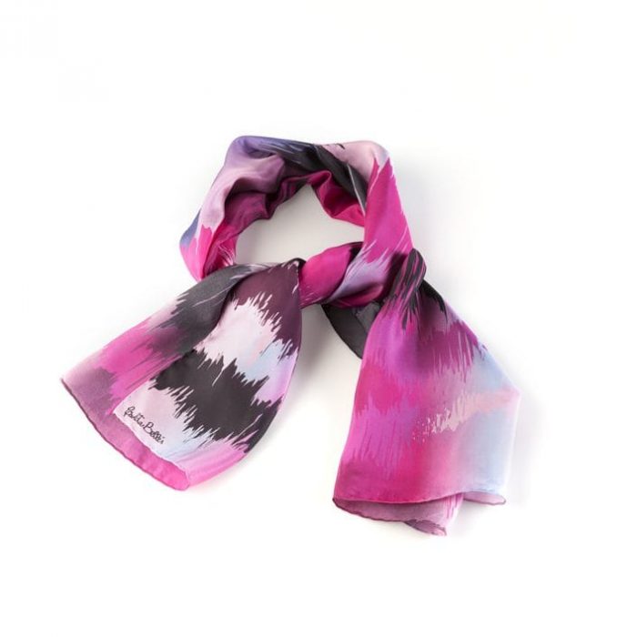 Large pink Sunset silk twill scarf draped, showcasing the abstract representation of light and color overlapping on the horizon.
