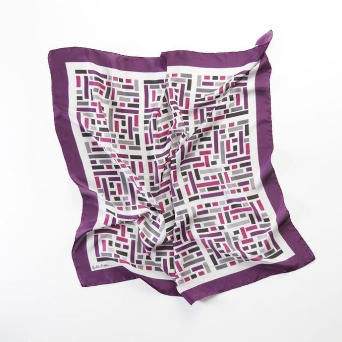 Close-up of the Wild West scarf, highlighting the high-quality silk twill and the rhythmic placement of varied-sized color rectangles. Barcelona design.