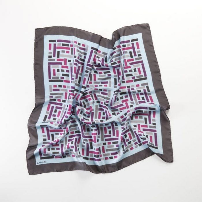 Detail of the Wild West scarf, focusing on the blend of blue and gray shades in the rectangular color blocks. Handmade luxury accessory.