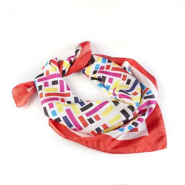 Close-up of the Wild West scarf, showing the fine silk twill texture and the varying sizes and shades of red rectangles