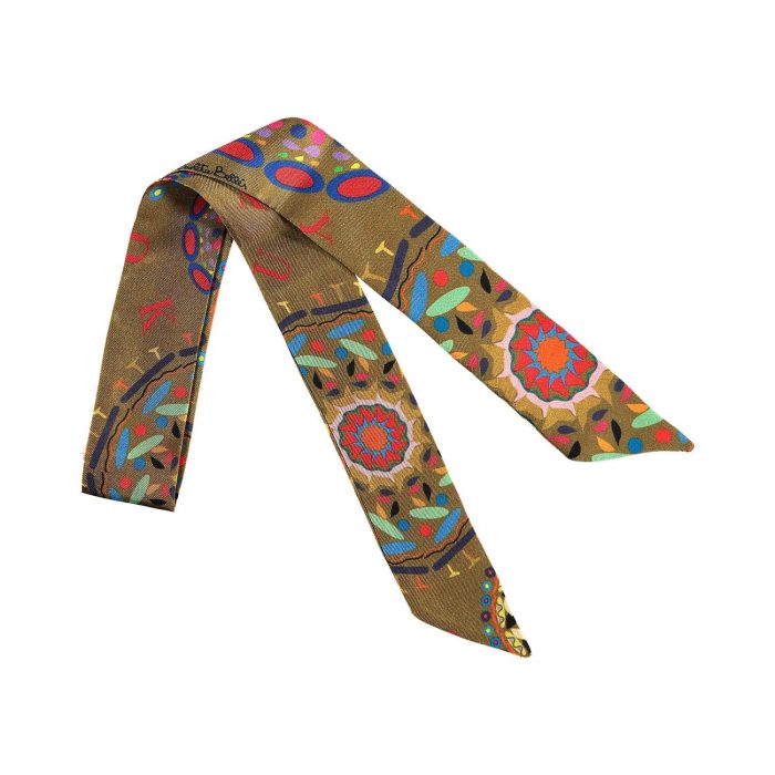 Folded Gratitude twilly, highlighting the three distinct mandalas in shades of blue, red, and yellow on the gray silk.