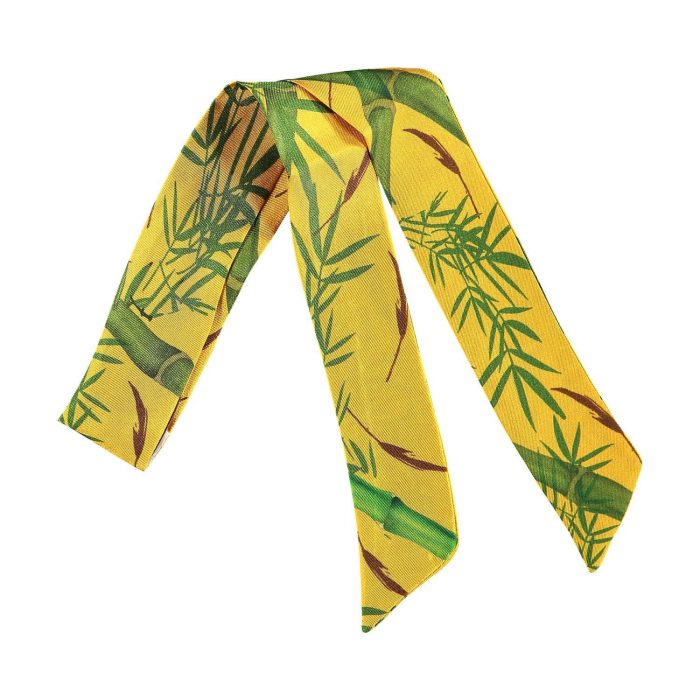 Bamboo twilly tied to a bag, showcasing the vertical stalks and graceful leaves pattern. Versatile and unique silk accessory made in Spain.