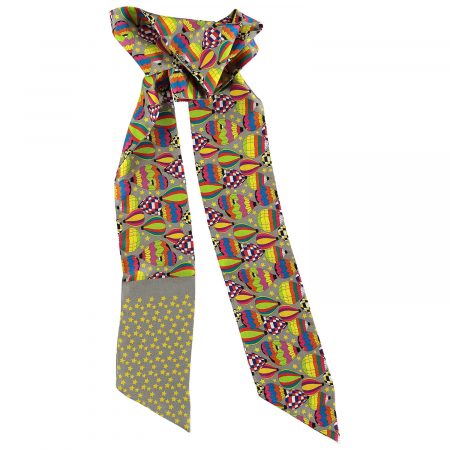 Gray silk twilly scarf with 'Joy' pattern, shown tied around the neck