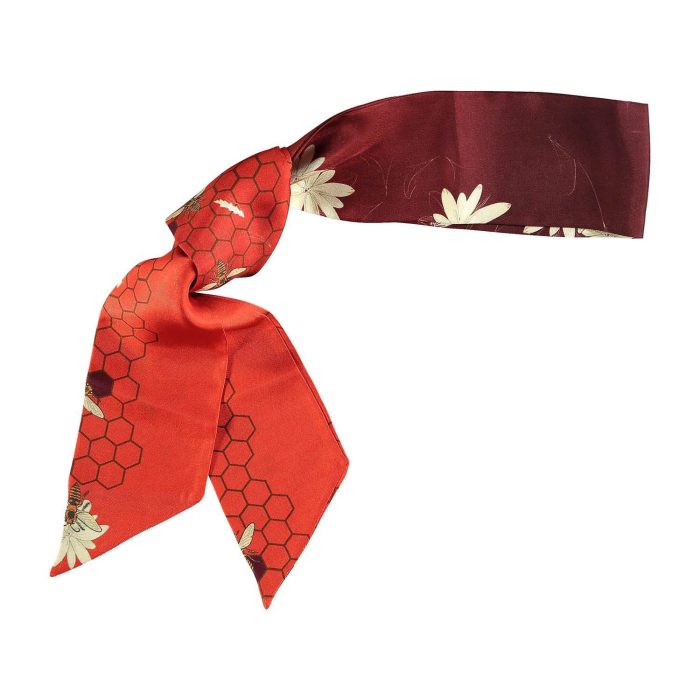Close-up of Melissae twilly showing a vibrant maroon gradient and delicate hand-drawn bee motifs. Versatile and elegant silk accessory for women.