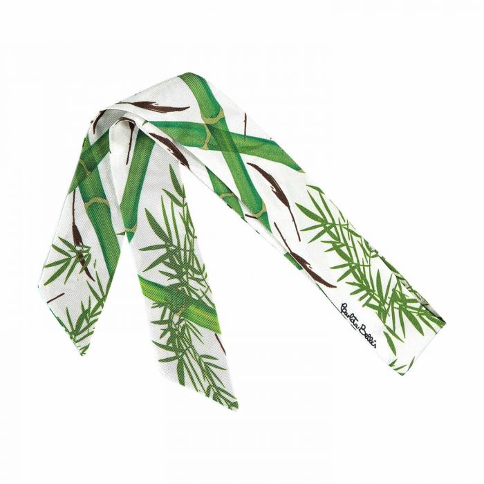 Detailed look at the delicate bamboo print on the luxury white silk twilly.